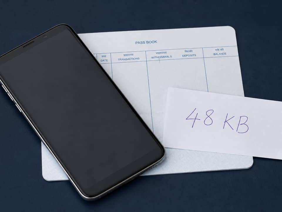 Phone on a passbook showing a 48KB JPG after a 50KB compress